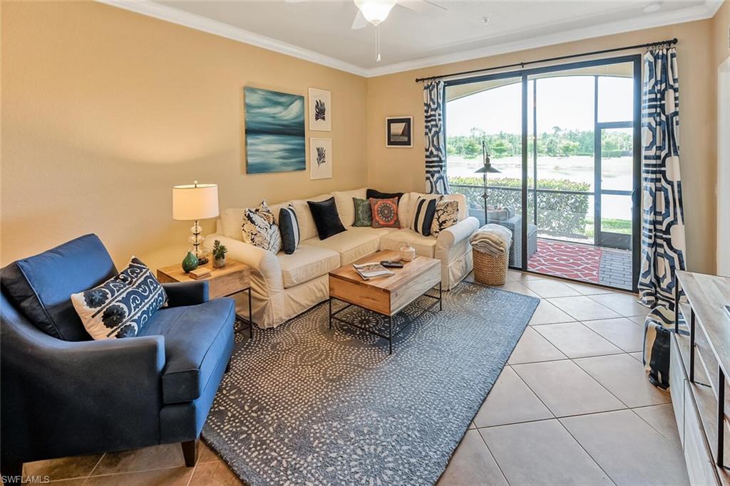 a living room with furniture and a floor to ceiling window