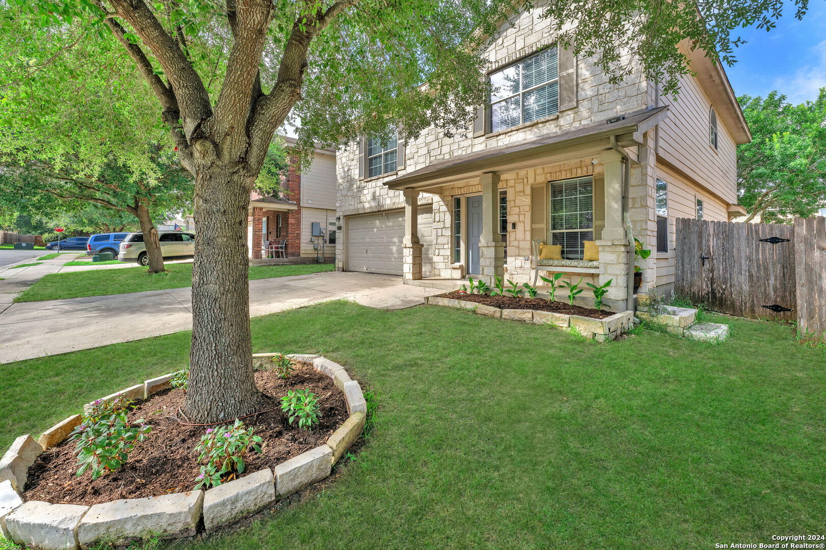 a front view of a house with a yard garden and outdoor seating