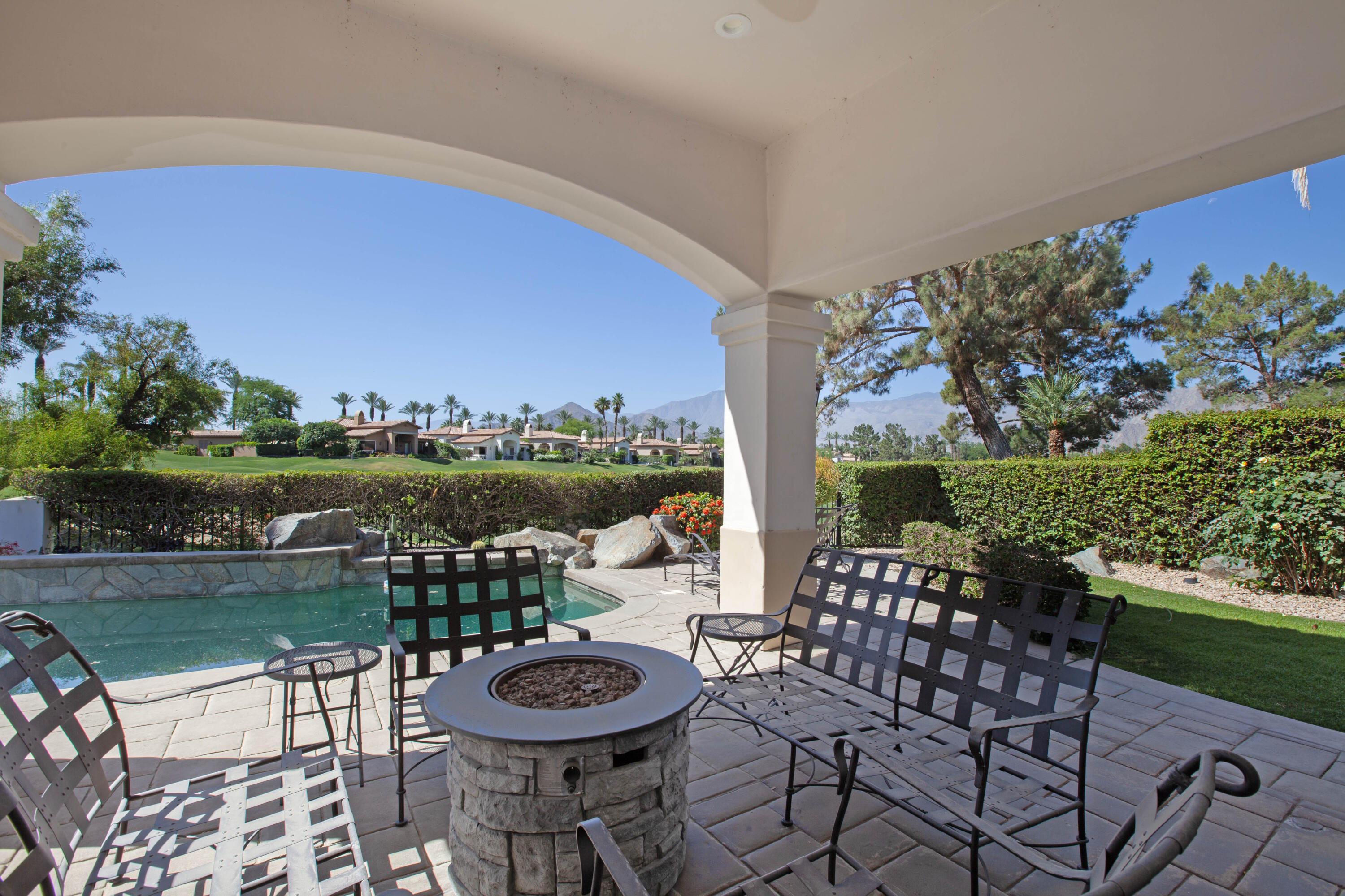 a view of a chairs and table in patio with a lake view