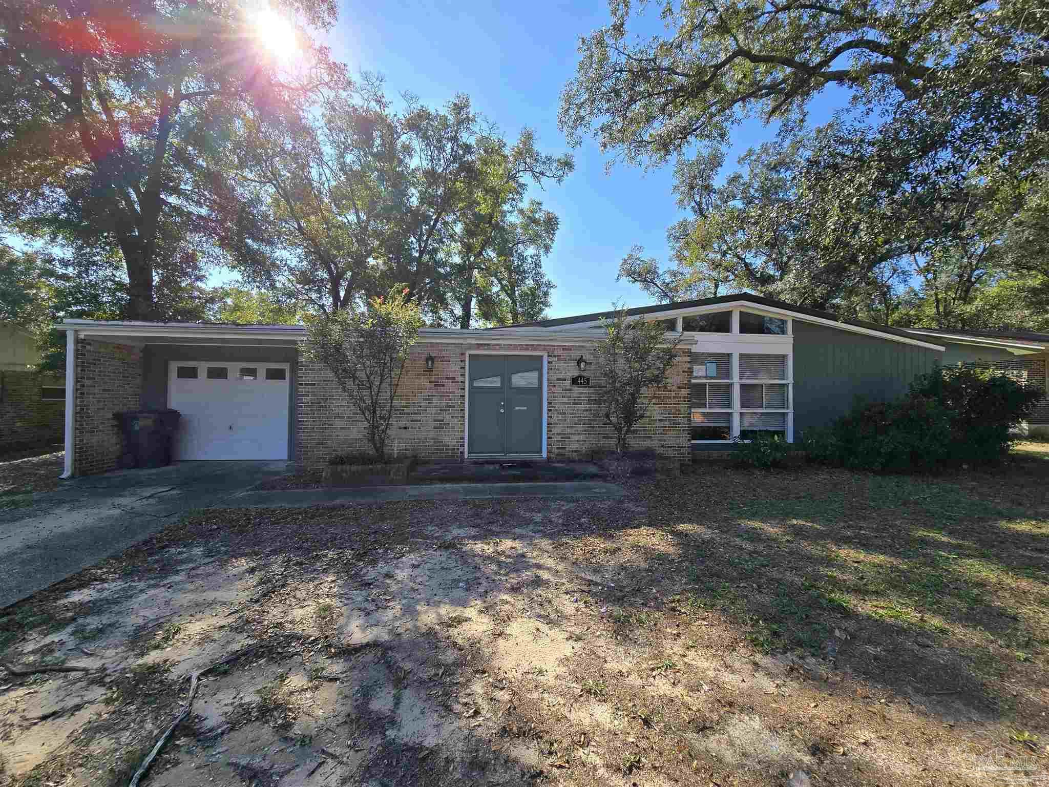 a view of a house with a yard and garage