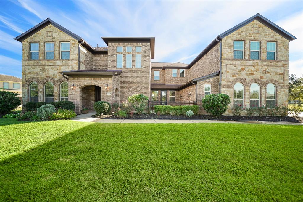 This stately home is both impressive and welcoming. Situated on ¾ of an acre, along the fairway of hole 11, there is a beautiful view from every. This home incorporates the perfect blend of variegated tumbled brick and stone, with mixed roof lines, adding interest and depth for excellent curb appeal.