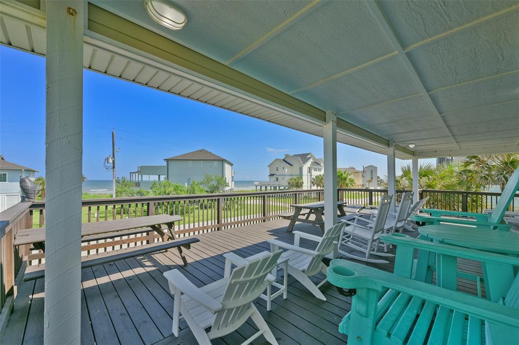 a view of a chairs and table on the balcony