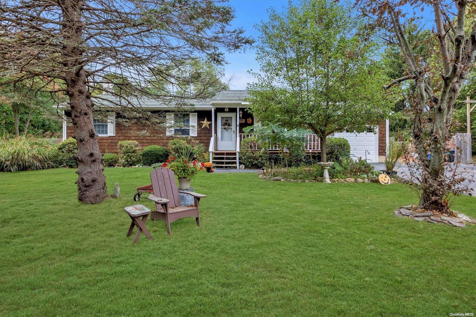 a view of a chair and table in backyard of the house