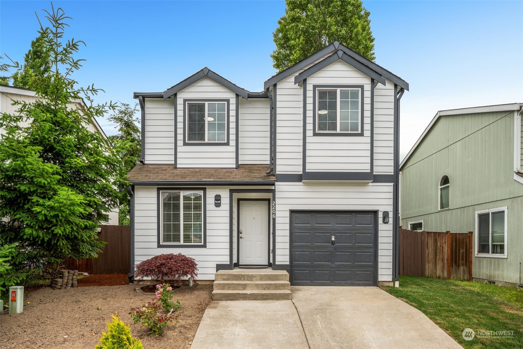 a front view of a house with a yard and garage