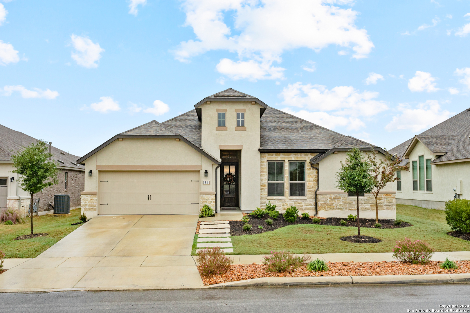 a front view of a house with a garden