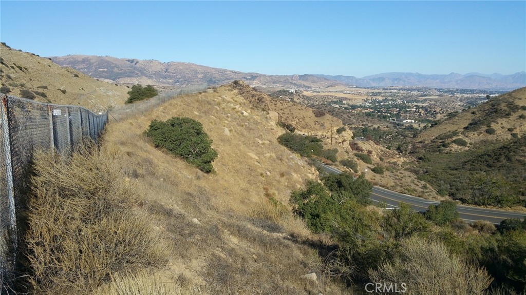 a view of a forest with mountains in the background