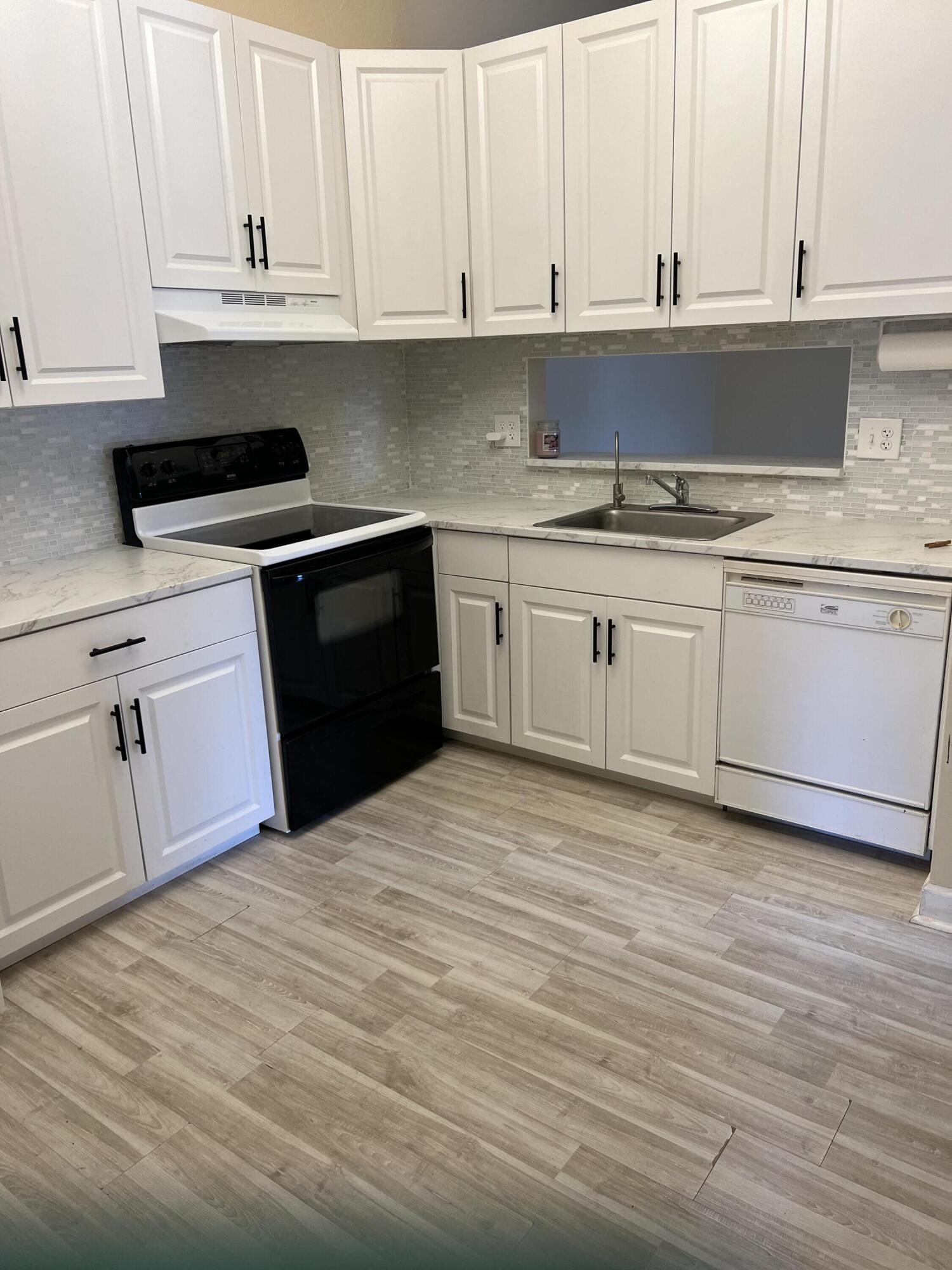 a kitchen with appliances cabinets and a sink