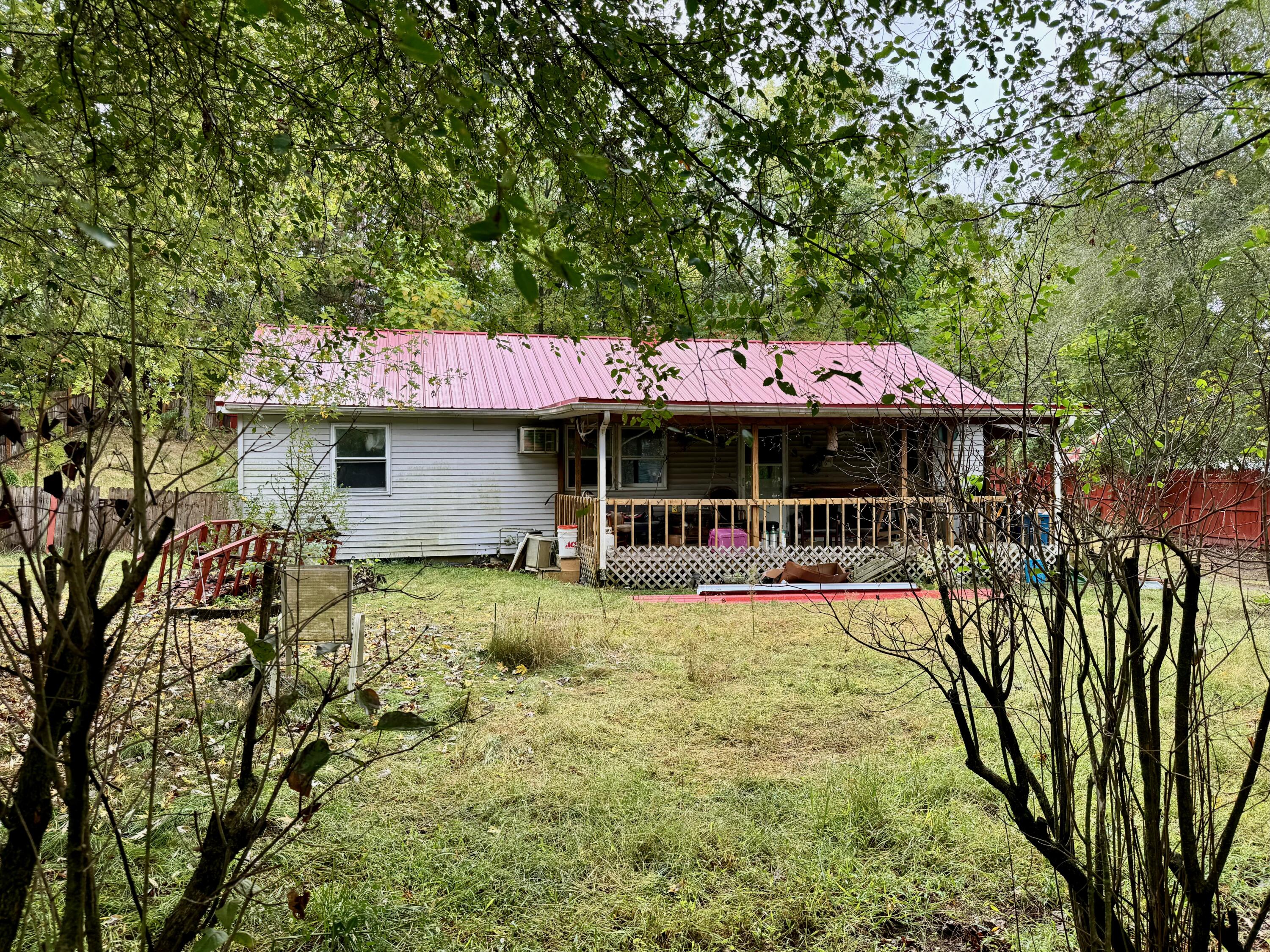 a front view of a house with a yard table and chairs