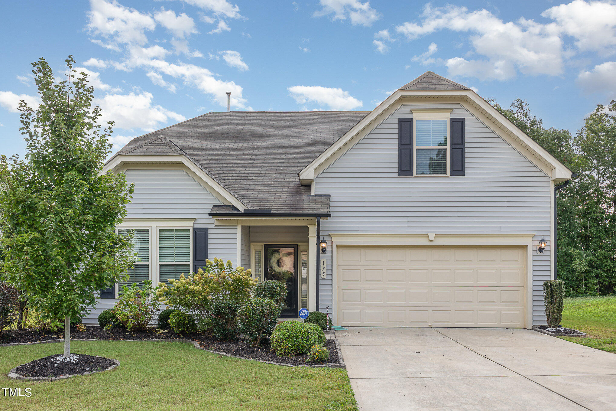 a front view of house with yard and green space