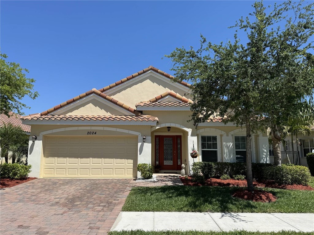 a front view of a house with a yard and outdoor seating