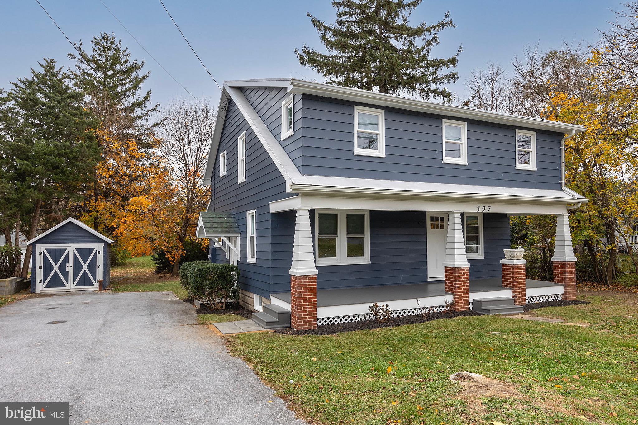 a view of a house with a yard porch and sitting area