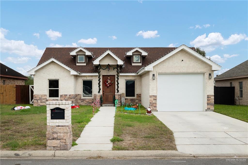 View of front facade with a garage and a front yard