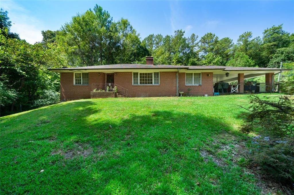 a front view of a house with yard and green space