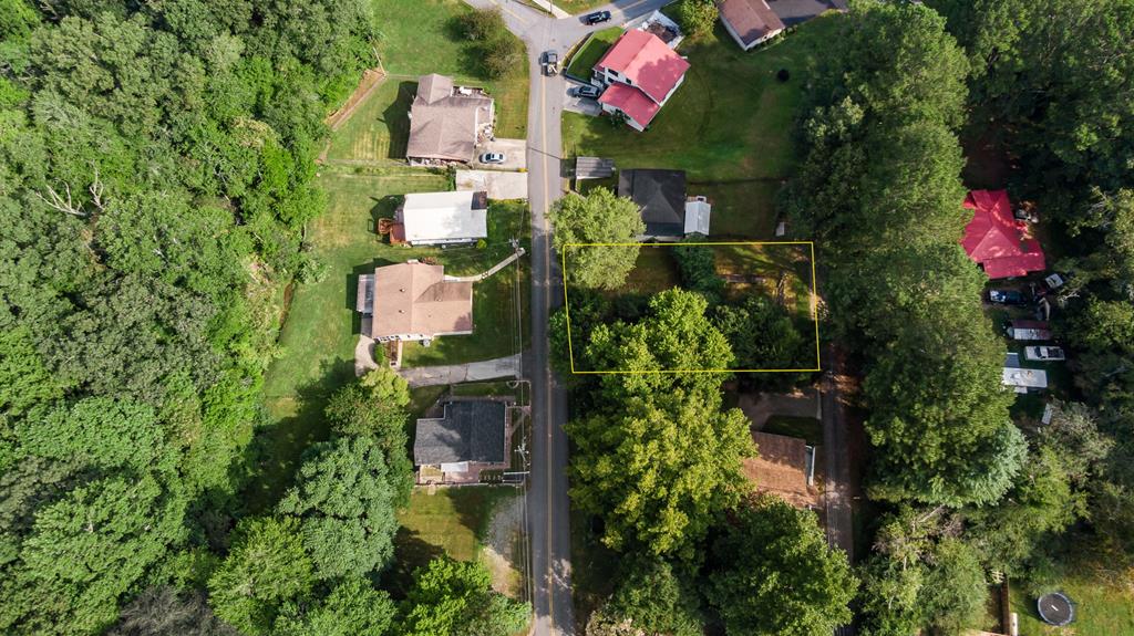 an aerial view of house with swimming pool outdoor seating and yard