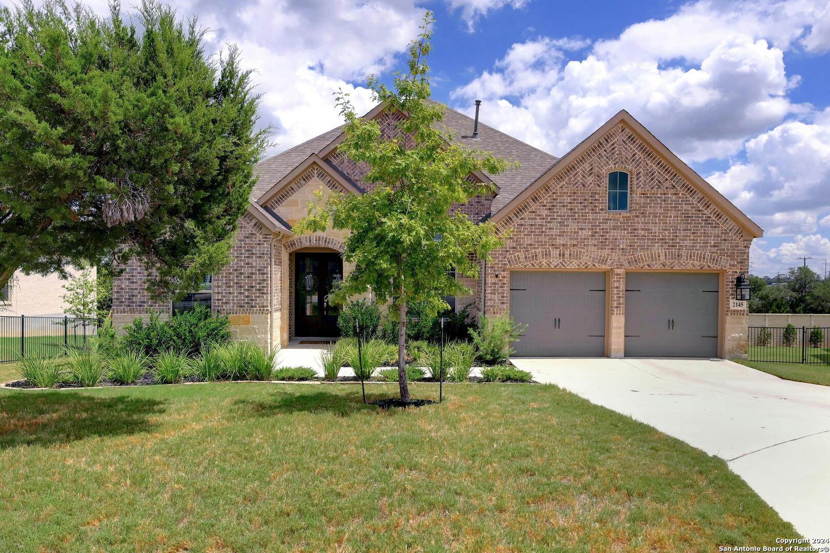 a front view of a house with a yard and garage