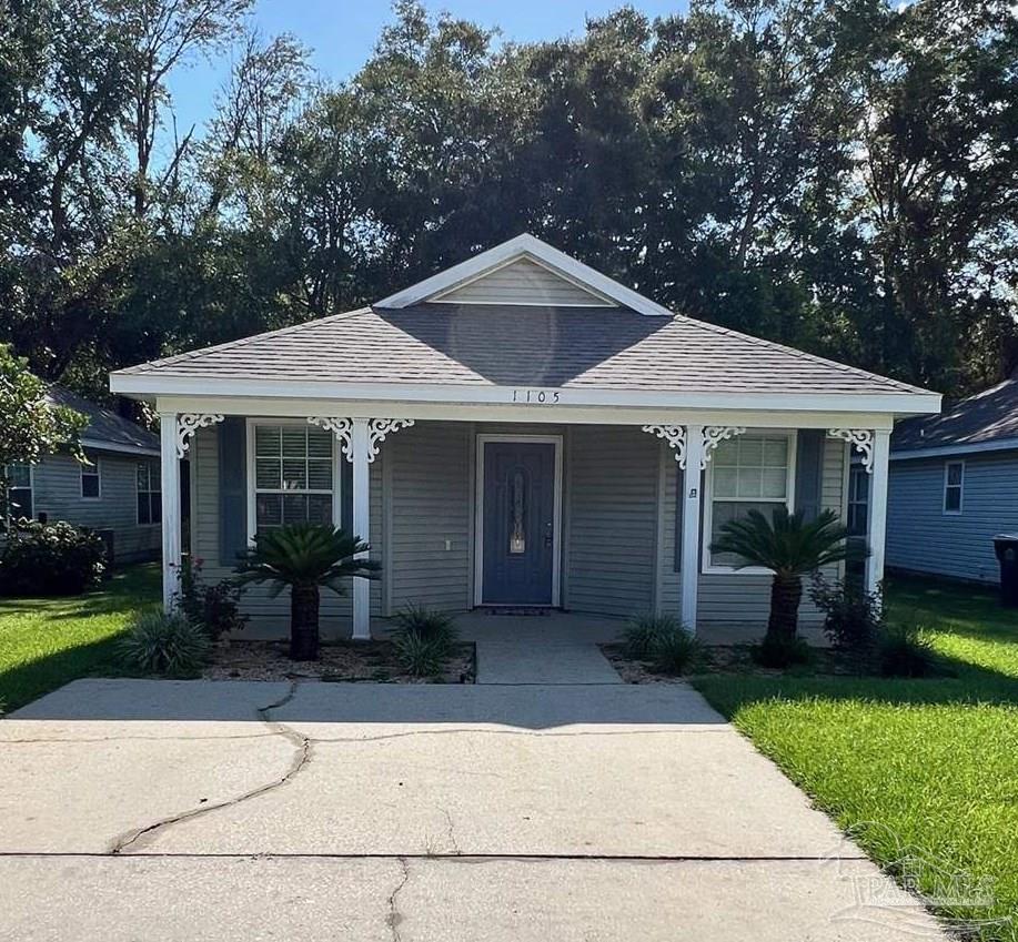 a front view of a house with garden