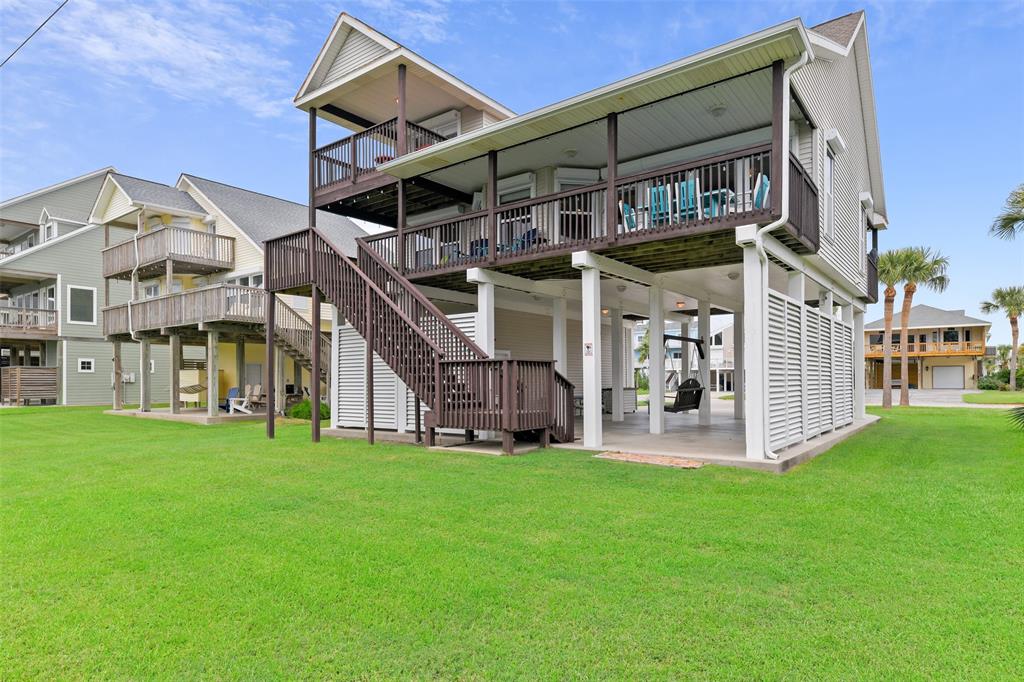 a view of a house with a yard and sitting area