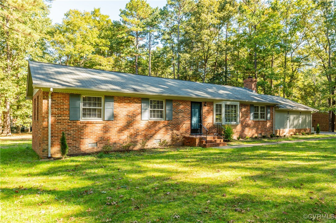 Single story home with a front lawn