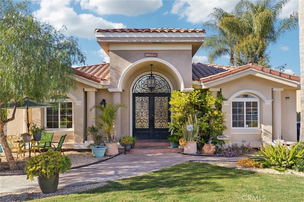 a front view of a house with garden