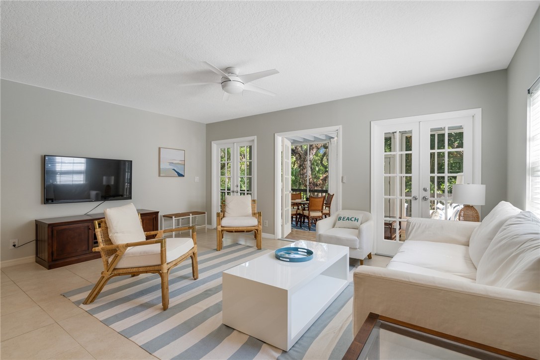 a living room with furniture a flat screen tv and a window