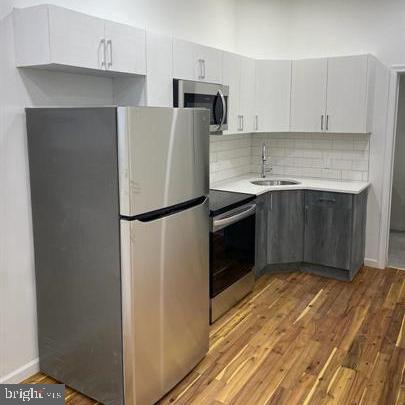 a kitchen with a refrigerator and a sink