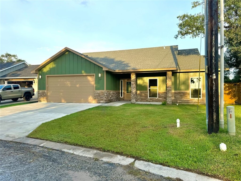 a front view of house with yard and green space