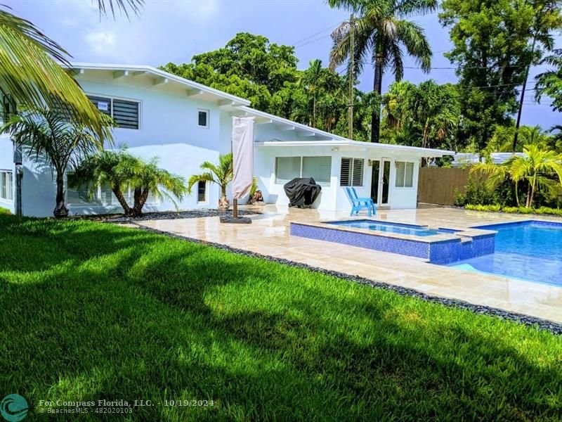 a house view with swimming pool and garden space