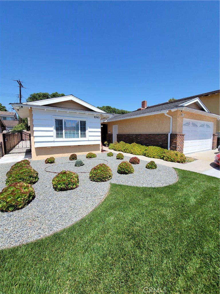 a front view of a house with garden