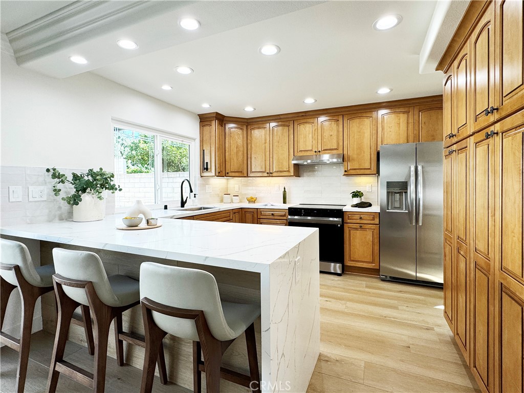 a kitchen with counter top space cabinets and stainless steel appliances