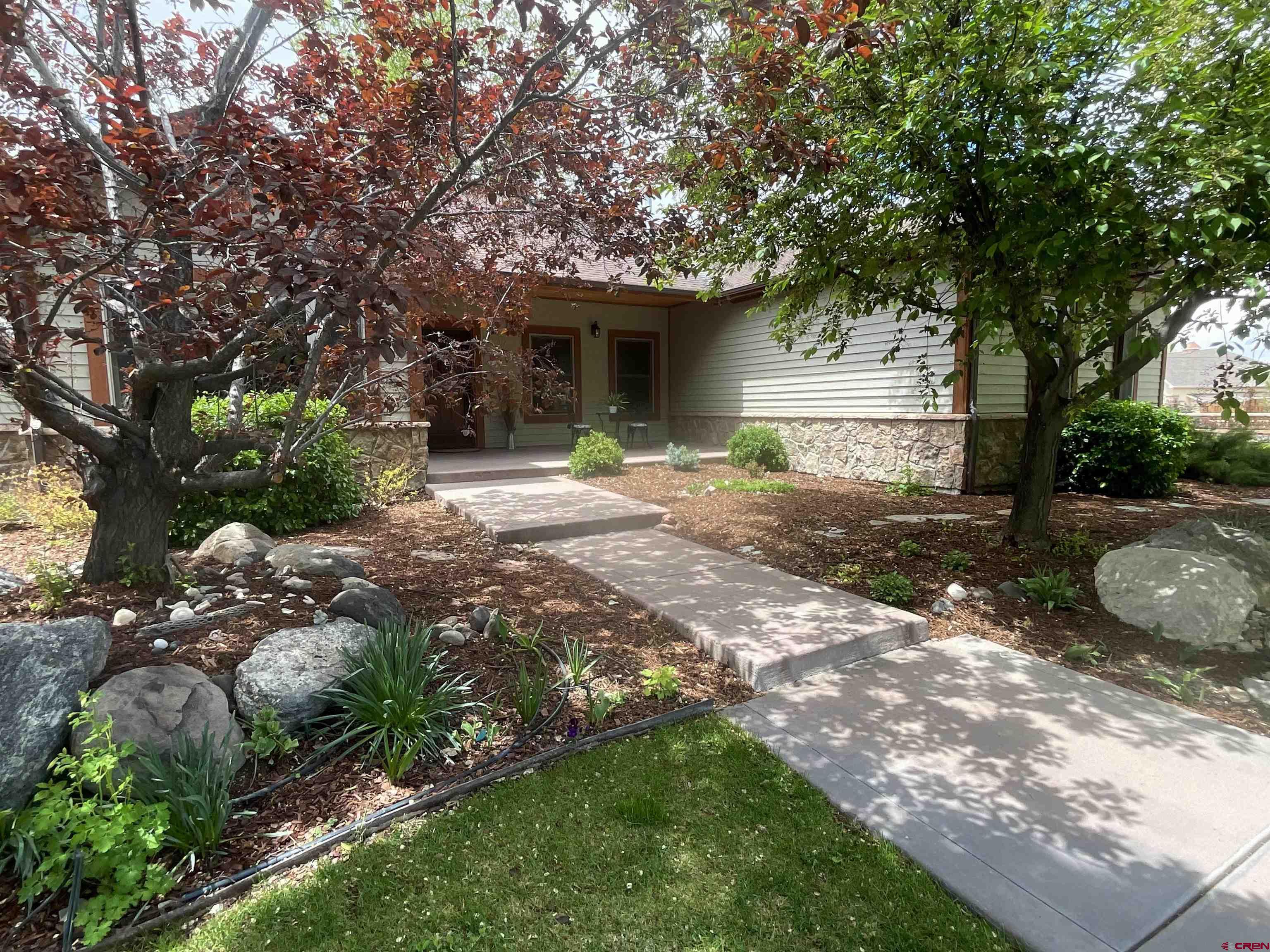 a view of a house with a tree in a yard