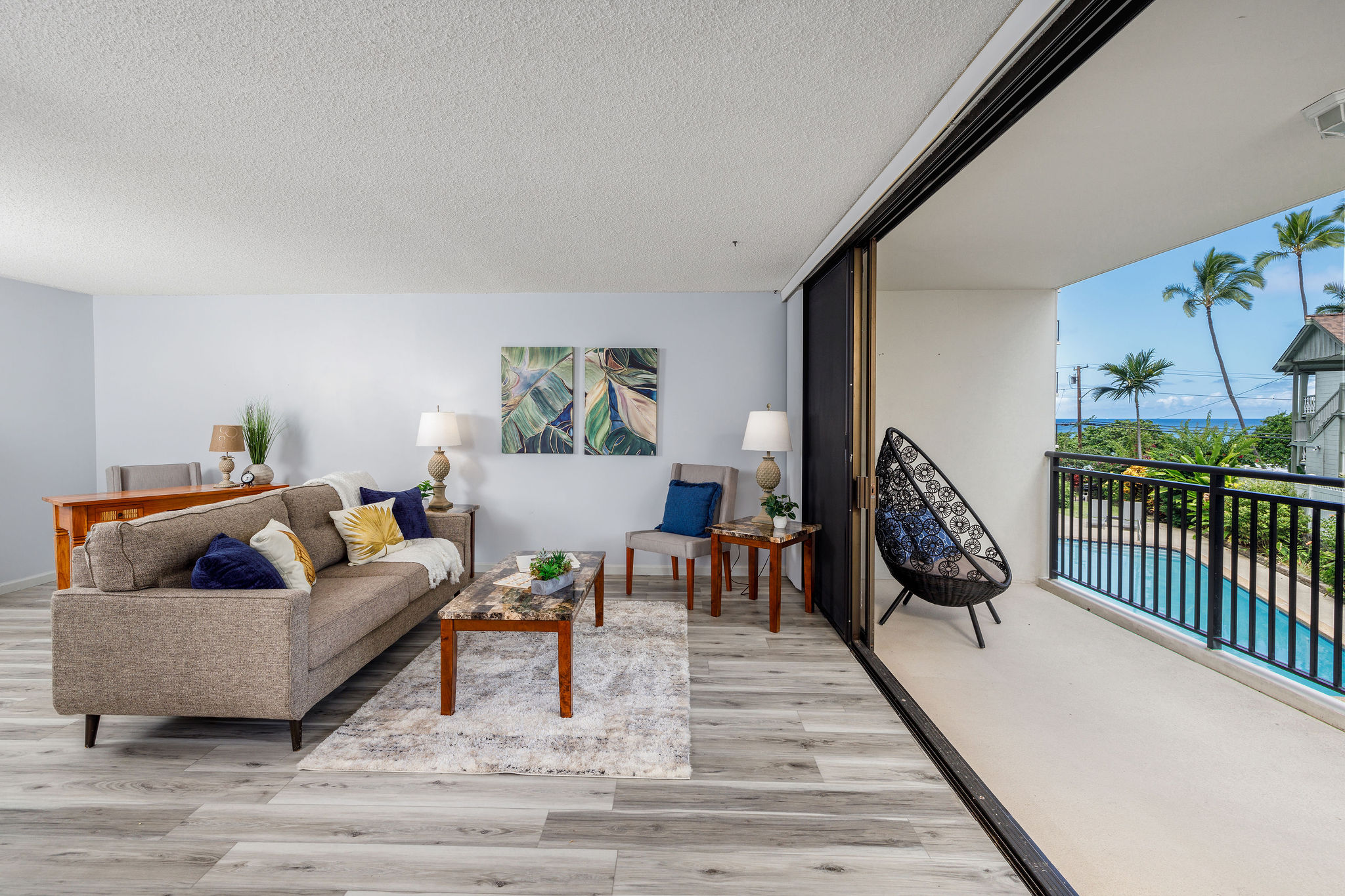 a living room with furniture and a wooden floor