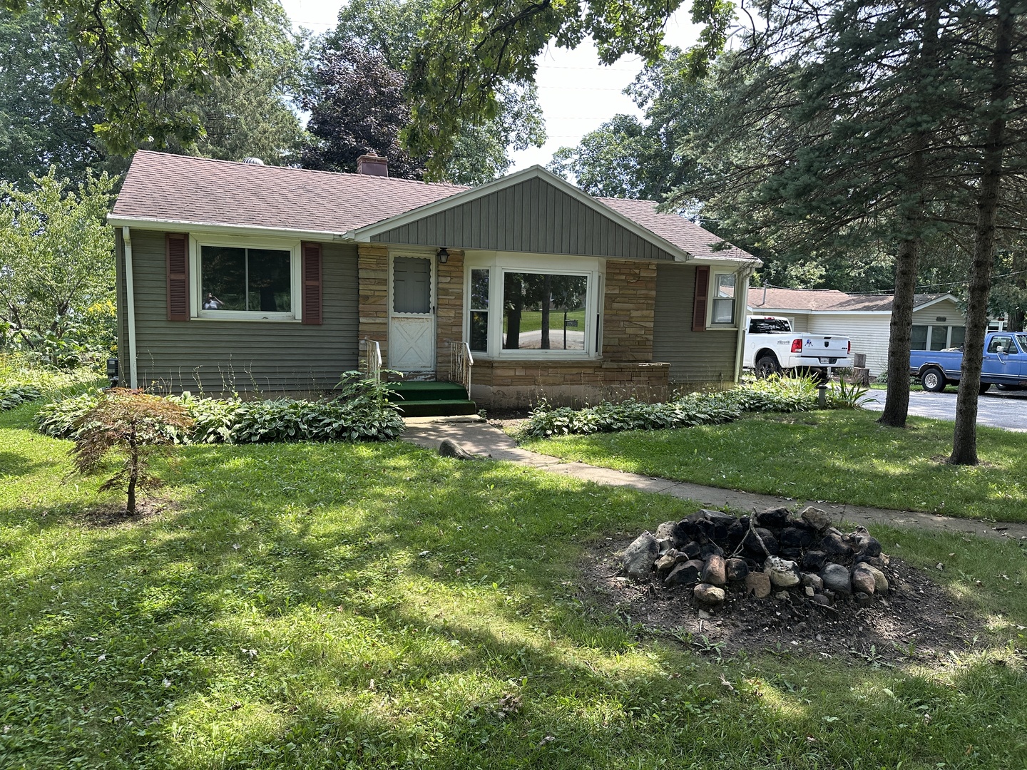 a view of a house with a yard and sitting area