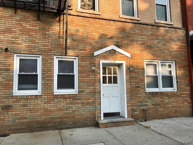 a view of a brick house with large windows