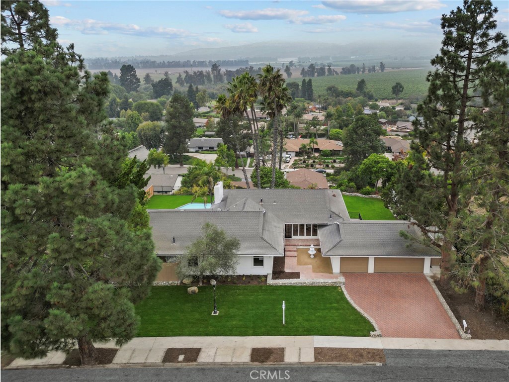 an aerial view of a house with yard