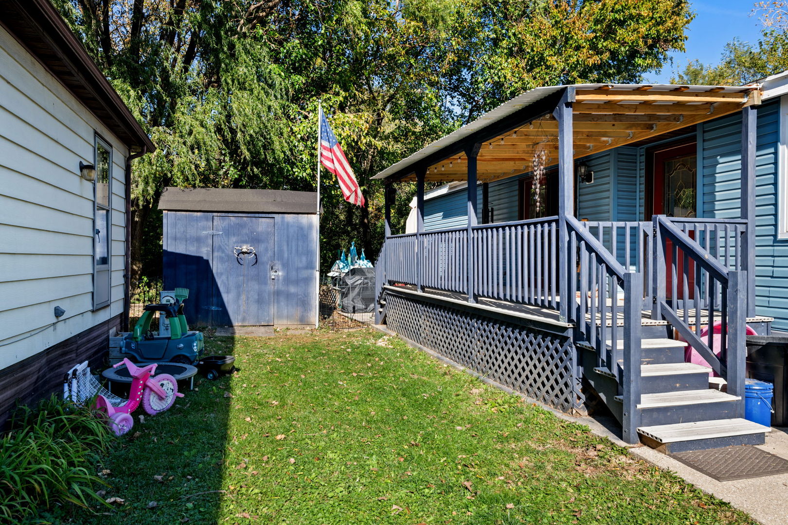 a view of backyard with deck and garden