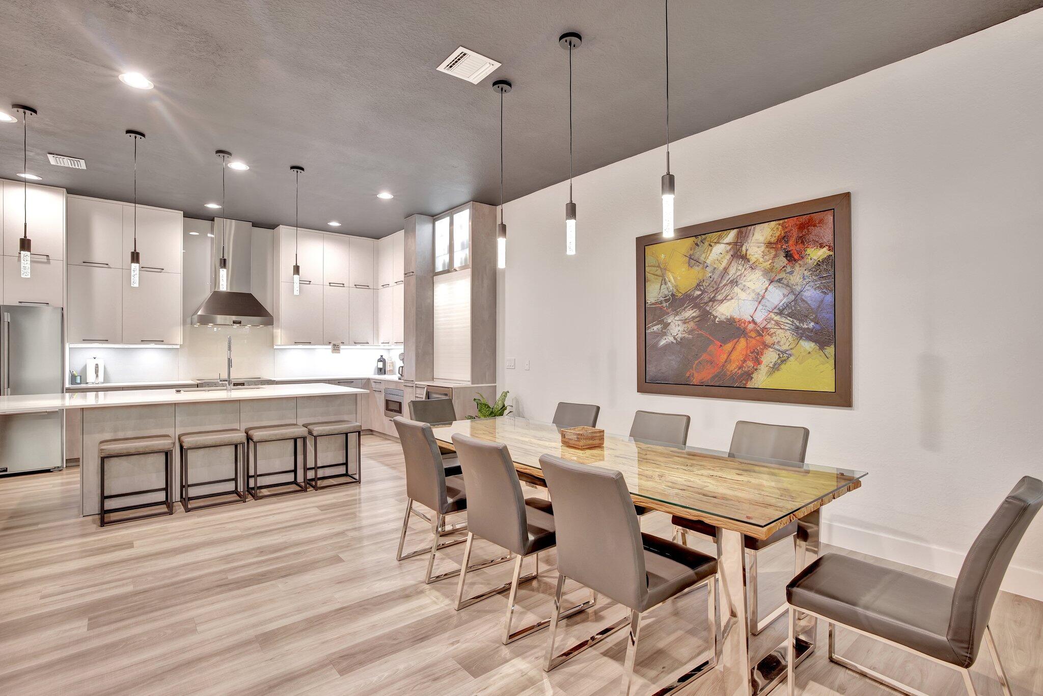 a large kitchen with a table and chairs