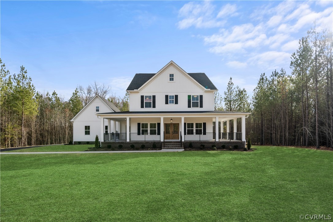 a front view of a house with a garden and trees