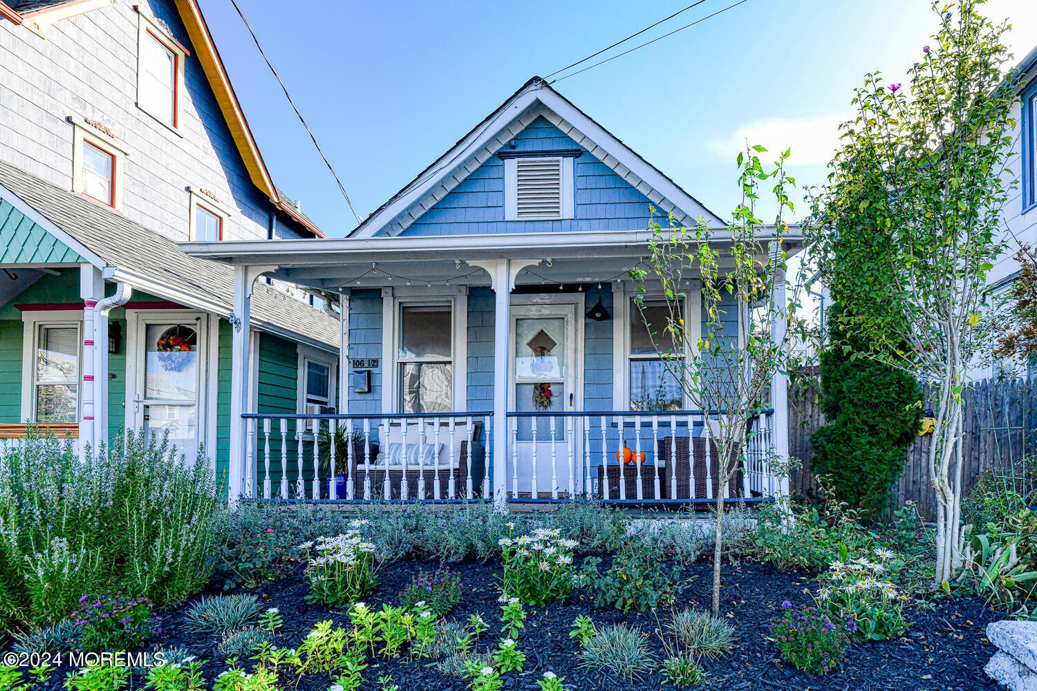 a view of a house with brick walls and flower plants