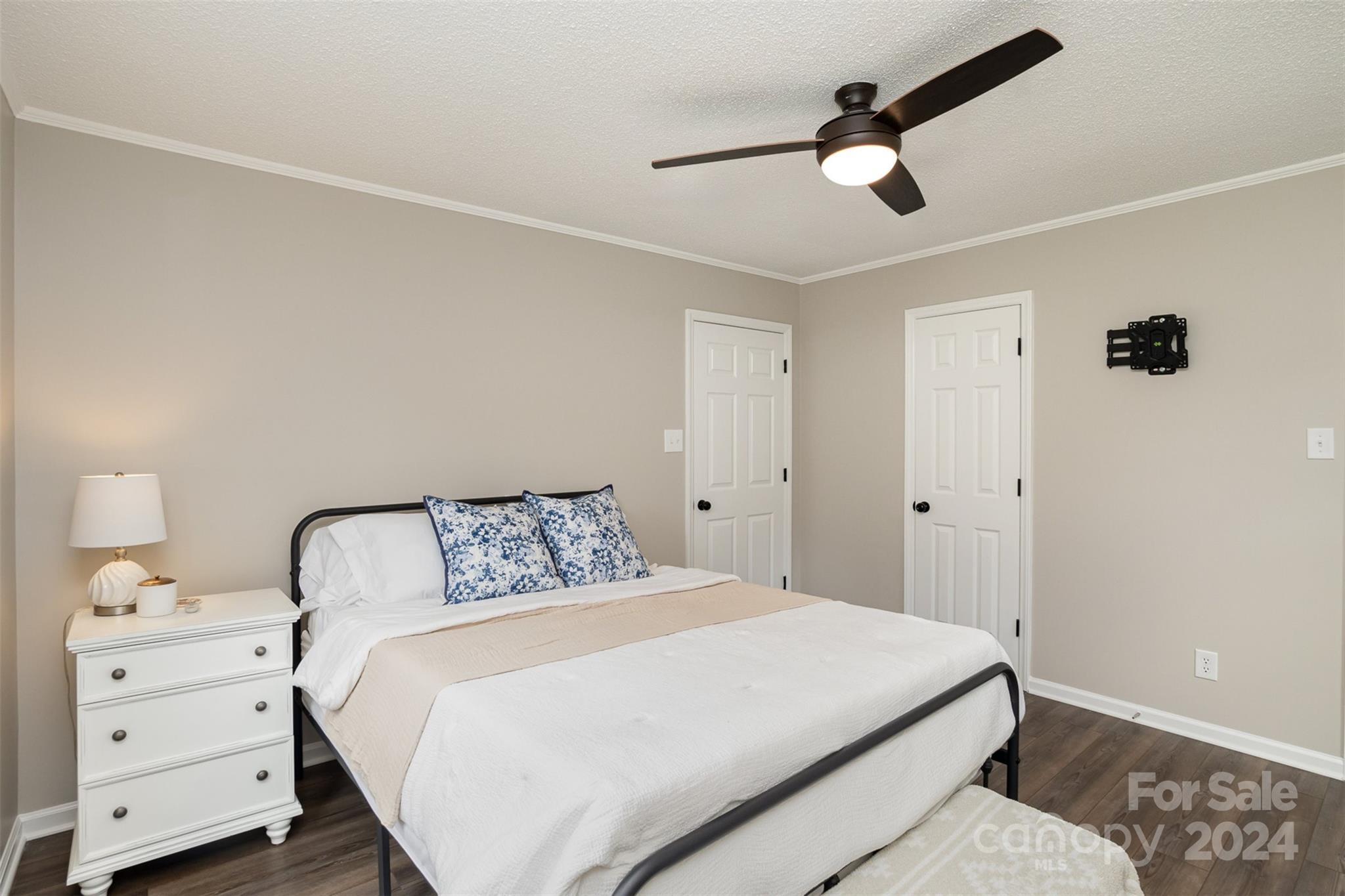 a bedroom with a bed and cabinets