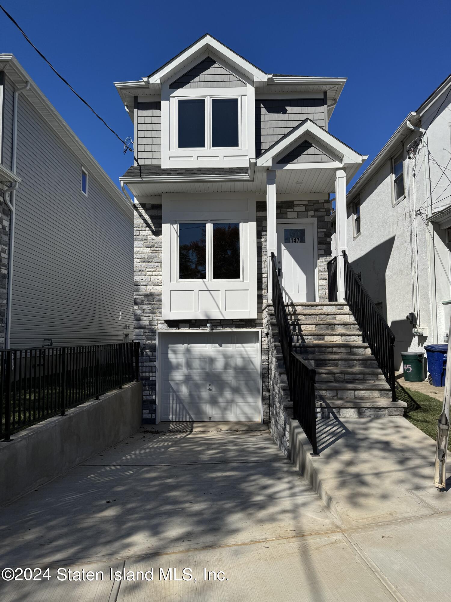 a front view of a house with many windows