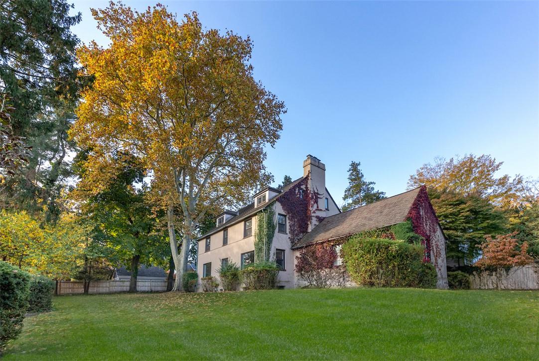 View of side of property with a lawn