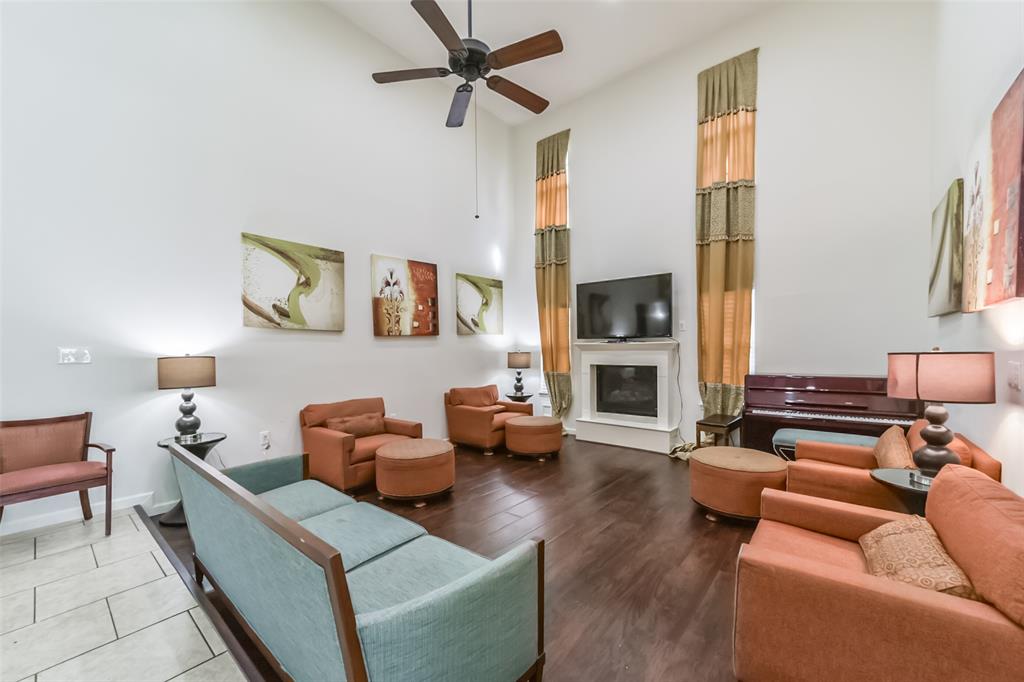 a living room with furniture wooden floor and a fireplace