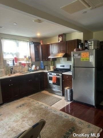 a kitchen with a sink refrigerator and microwave