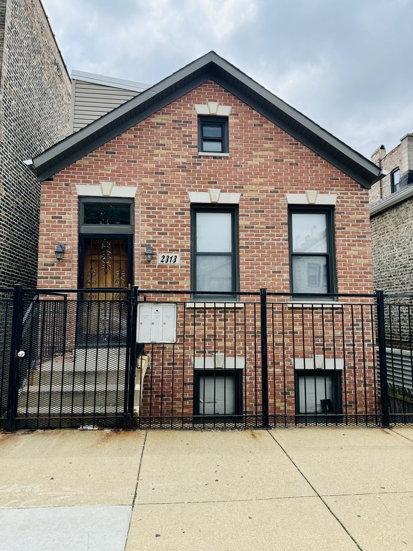 a view of a brick house with large windows