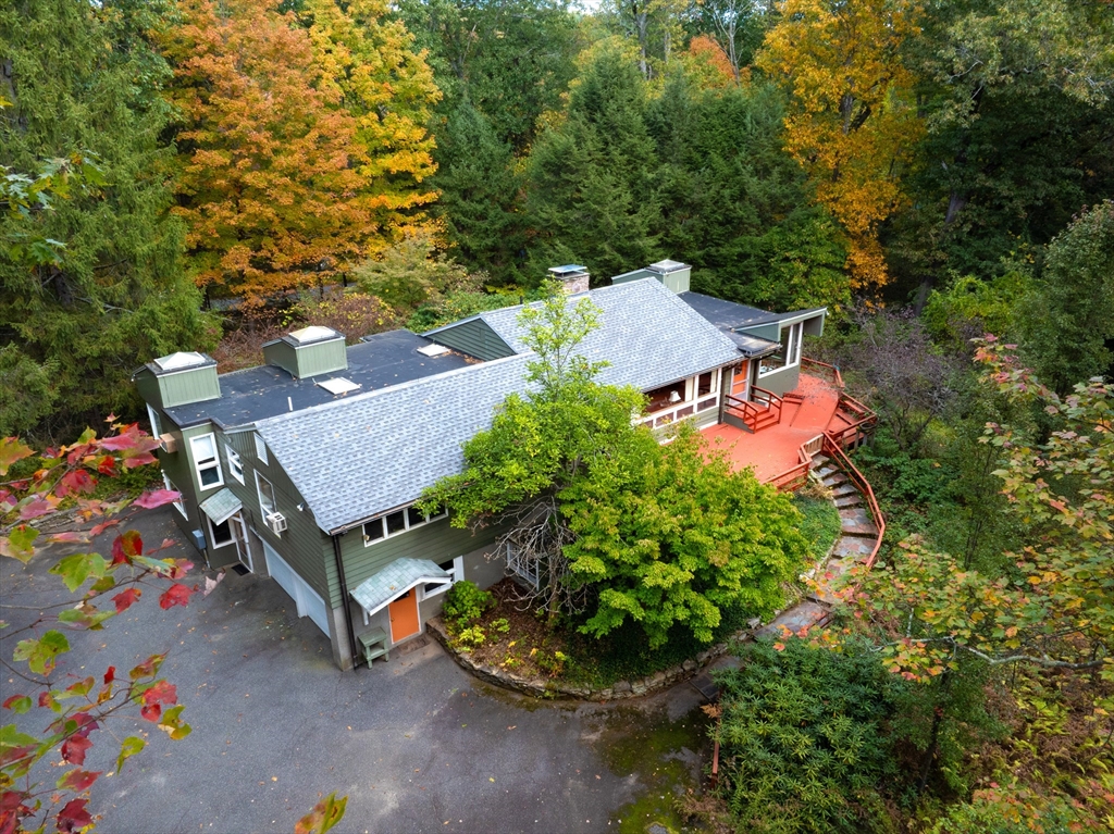 an aerial view of a house with garden space and street view