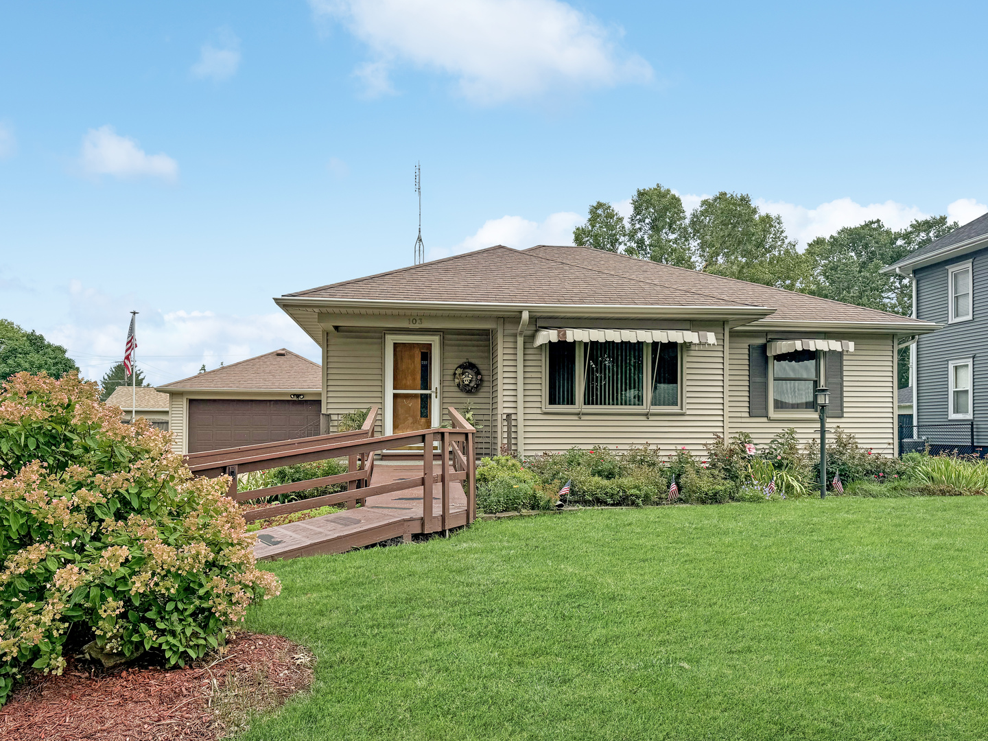 a front view of a house with a garden