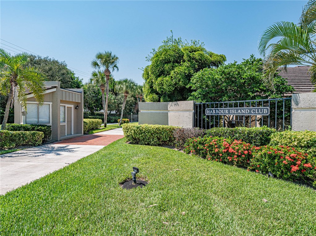 a view of a garden with a house in the background