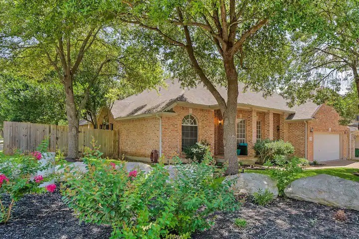 a front view of a house with garden