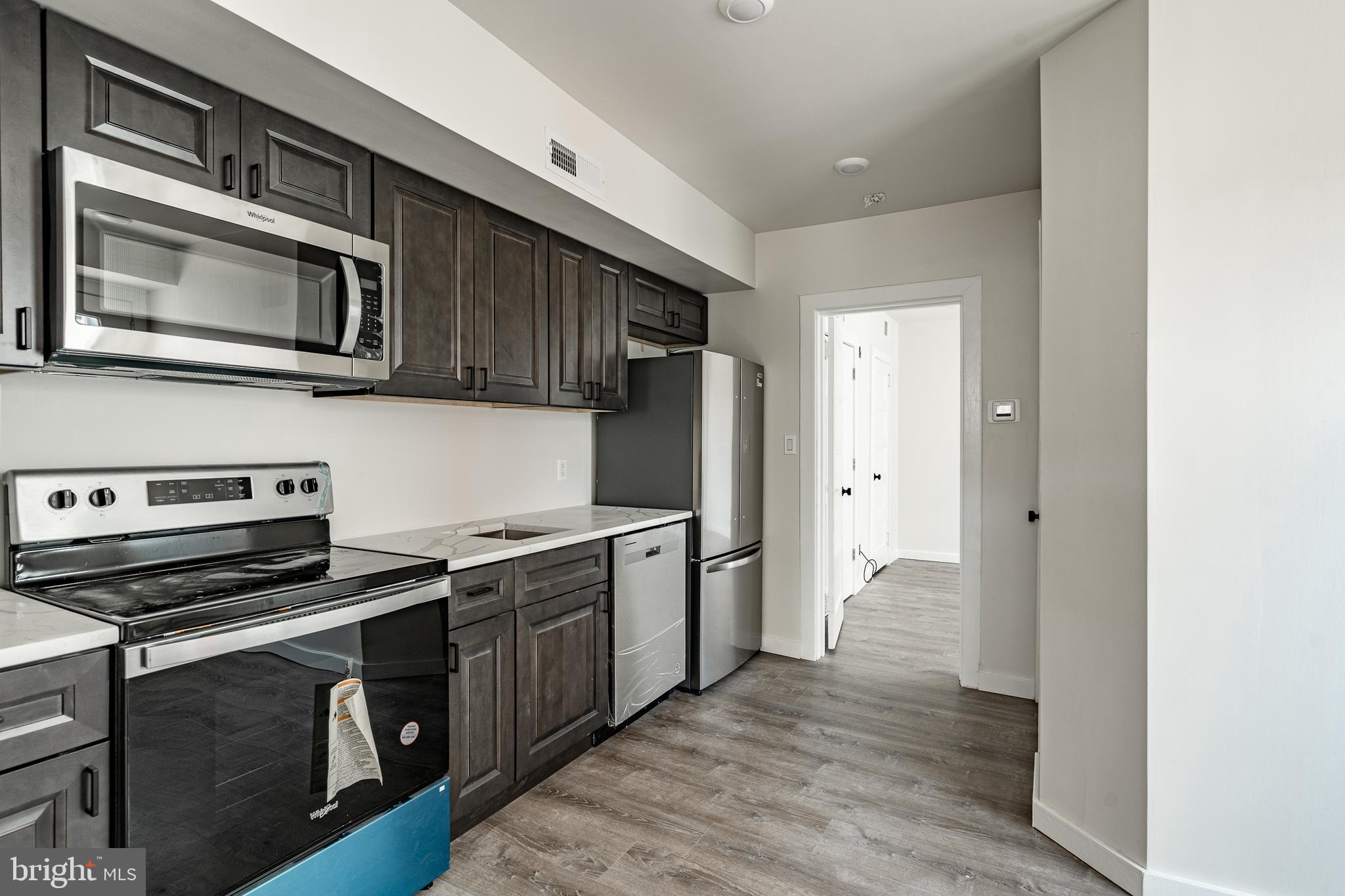 a kitchen with stainless steel appliances a stove microwave and a refrigerator