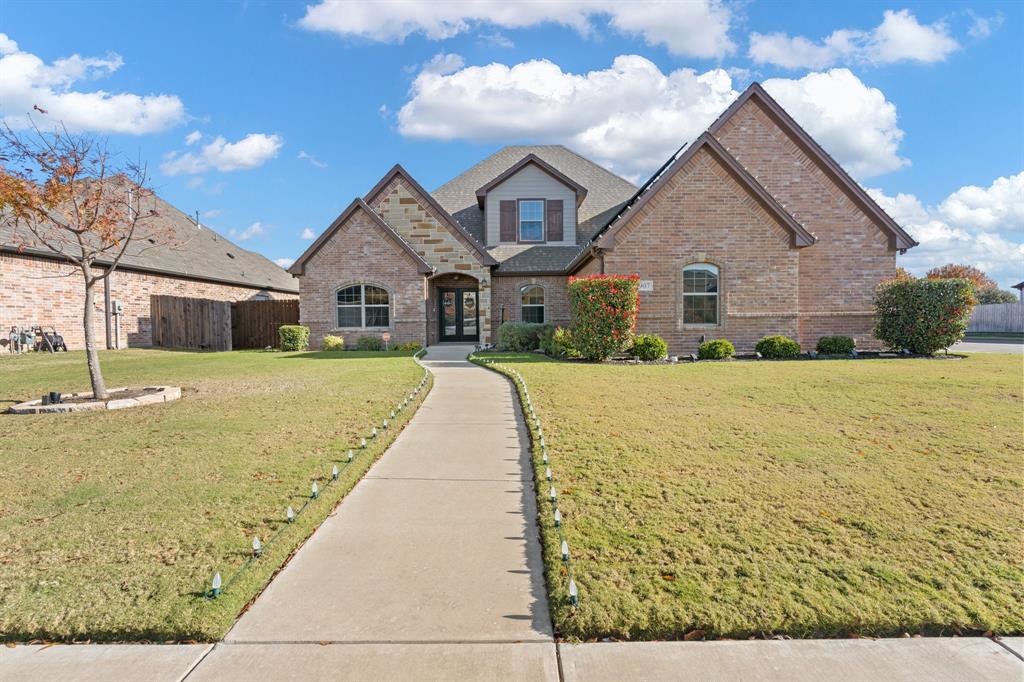 a front view of house with yard and green space